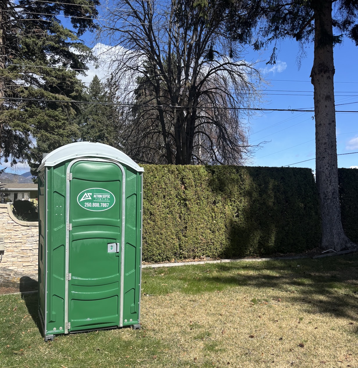 Action Septic branded standard portable toilet at a residential property in the Okanagan